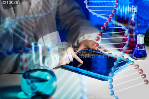 Image of close up of scientist with tablet pc in laboratory