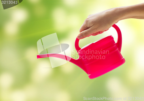 Image of close up of woman hand holding watering can