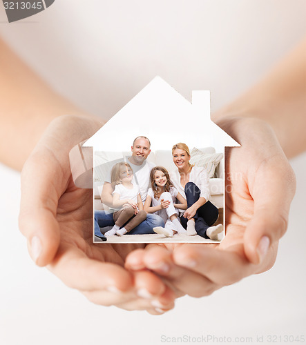 Image of close up of hands holding house shape with family