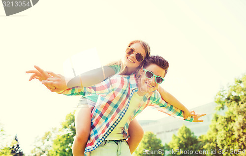 Image of smiling couple having fun in park