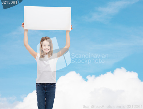 Image of smiling little girl holding blank white board