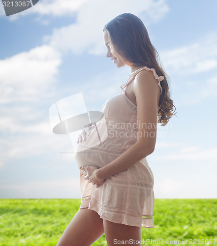 Image of happy pregnant woman in chemise