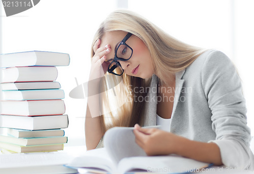 Image of student with books and notes