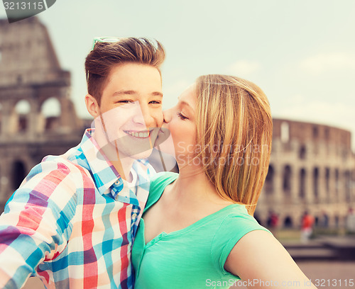 Image of couple kissing and taking selfie over coliseum