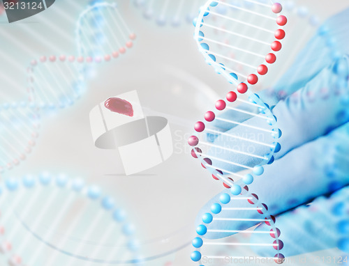 Image of close up of scientist with blood sample in lab