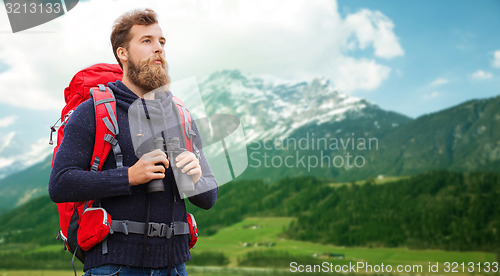 Image of man with backpack and binocular outdoors