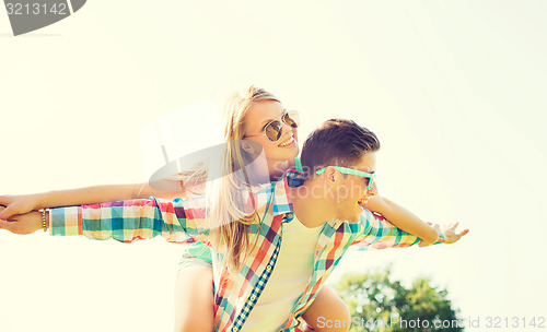 Image of smiling couple having fun in park