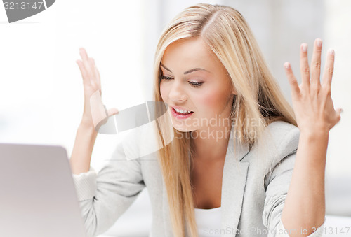 Image of angry woman with laptop