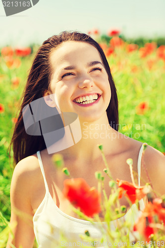 Image of laughing young woman on poppy field