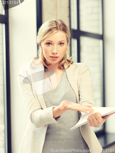 Image of worried woman with documents