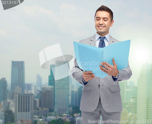 Image of happy businessman with open folder