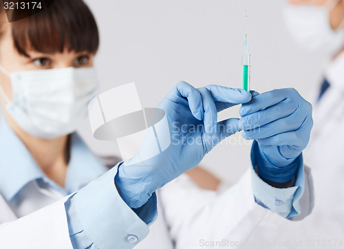 Image of doctors with syringe