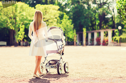 Image of happy mother with stroller in park