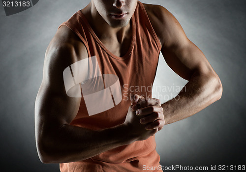 Image of young man showing biceps