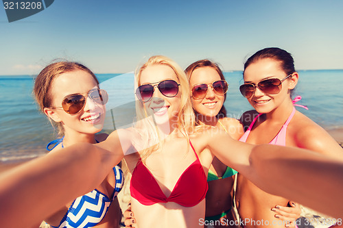 Image of group of young smiling women making selfie