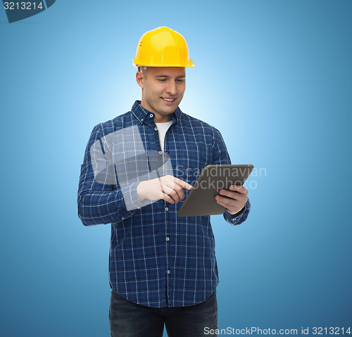 Image of smiling male builder in helmet with tablet pc