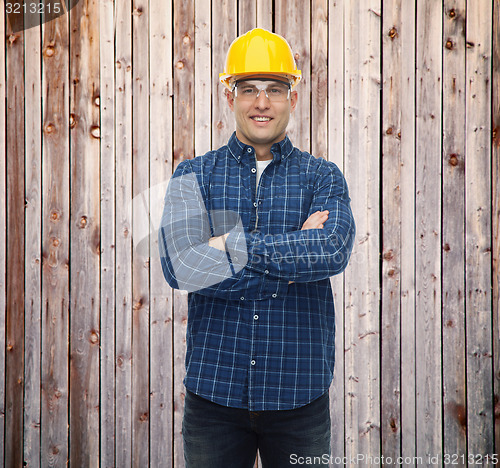 Image of smiling male builder or manual worker in helmet