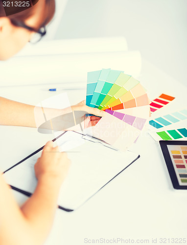 Image of woman working with color samples for selection