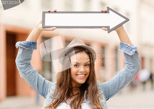 Image of girl showing direction with arrow in the city