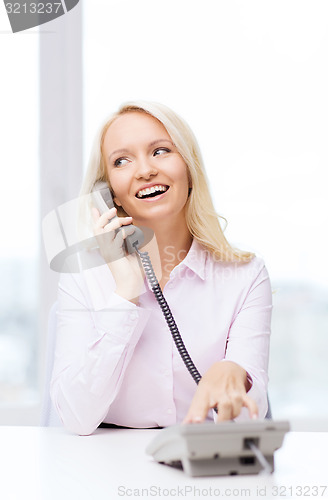 Image of smiling businesswoman or student calling on phone