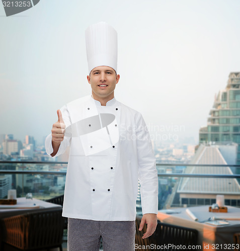 Image of happy male chef cook showing thumbs up