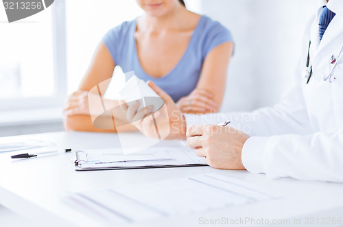 Image of patient and doctor prescribing medication