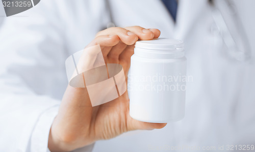 Image of doctor hands holding white pack