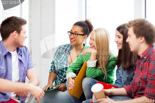 Image of students communicating and laughing at school