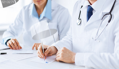 Image of doctor and nurse writing prescription paper