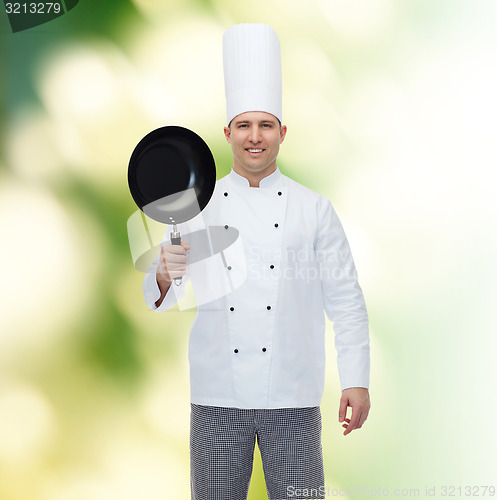 Image of happy male chef cook holding frying pan