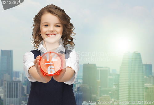 Image of happy girl with alarm clock 