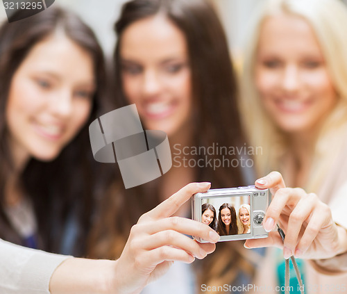 Image of beautiful girls taking selfie in the city