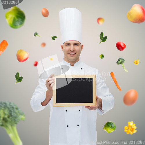 Image of happy male chef cook holding blank menu board