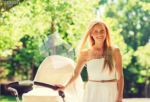 Image of happy mother with stroller in park