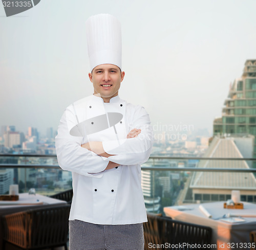 Image of happy male chef cook with crossed hands