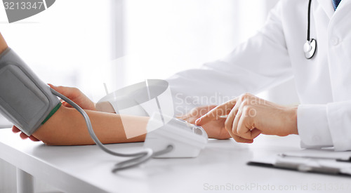 Image of doctor and patient measuring blood pressure