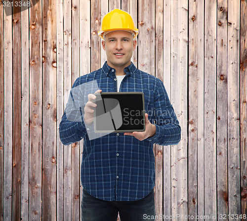 Image of smiling male builder in helmet with tablet pc