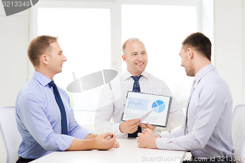 Image of smiling businessmen with papers in office