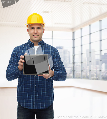 Image of smiling male builder in helmet with tablet pc