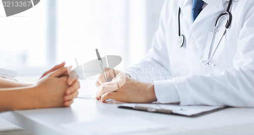 Image of patient and doctor taking notes