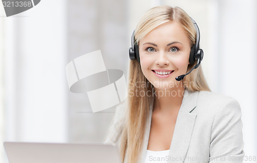 Image of friendly female helpline operator with laptop