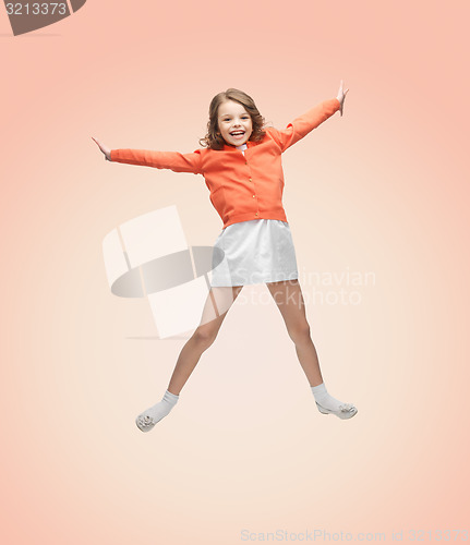 Image of happy girl in casual clothes jumping high