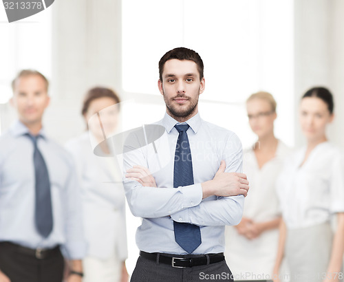 Image of handsome businessman with crossed arms