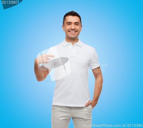 Image of smiling man in t-shirt pointing finger on himself