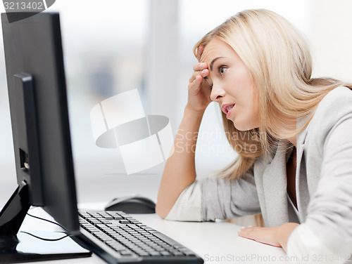 Image of stressed woman with computer