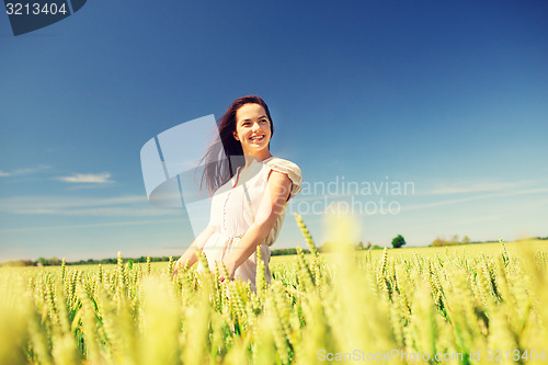 Image of smiling young woman on cereal field