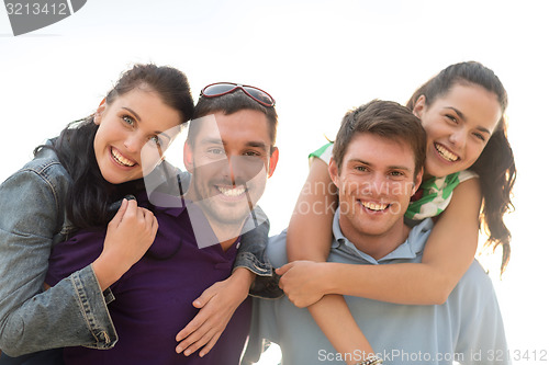 Image of group of happy friends having fun outdoors