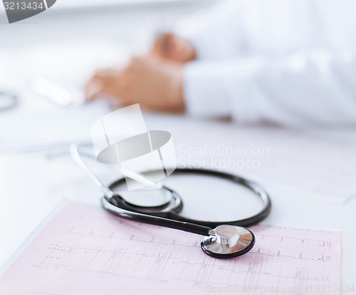 Image of male doctor hands with cardiogram