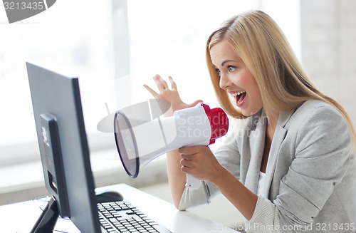 Image of crazy businesswoman shouting in megaphone