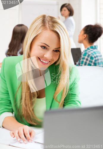 Image of student girl with laptop in college
